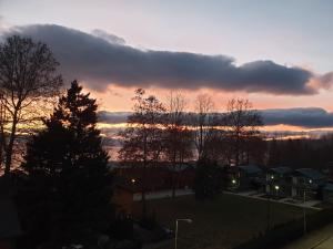 a sunset over a city with trees and houses at Villa & Apartments Antigona in Ohrid