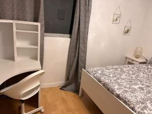 a small bedroom with a bed and a chair at 2 Superbes chambres d hôte dans un appartement avec magnifique vue sur Paris in Sucy-en-Brie