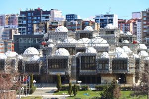 a building with white domes on top of it at Central View Apartment in Pristina