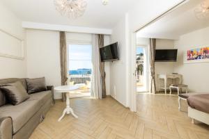 a living room with a couch and a table at Grand Hotel Park in Dubrovnik