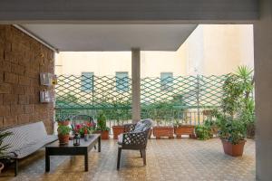 a patio with chairs and tables and potted plants at Bellariva Home in Florence