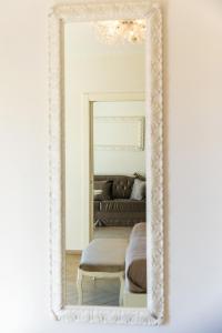 a mirror in a white frame in a bedroom at Grand Hotel Park in Dubrovnik