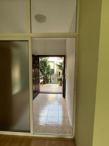 a view of a hallway with a door into a room at Huge Apartment with a Garden in the City Center in Prishtinë