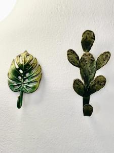 two green plants on a white wall at Residence Capobianco in Portoferraio
