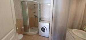 a bathroom with a washing machine and a washer at Bas de maison de village cosy & relax in Vero +19 photos