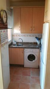 a kitchen with a washing machine and a sink at Torrox Costa in Málaga
