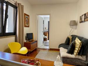 a living room with a couch and a table at Refúgio da Vila - Refuge of the Village in Vouzela