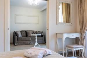 a living room with a couch and a mirror at Grand Hotel Park in Dubrovnik