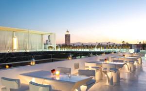 a row of tables and chairs on a rooftop patio at Riad Elisa & Spa in Marrakesh