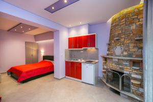 a bedroom with a bed and a stone fireplace at Villa Dimitris in Potos