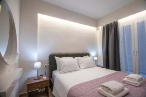 a bedroom with a bed with two towels on it at Luxury Apartment Marine View in Agios Nikolaos