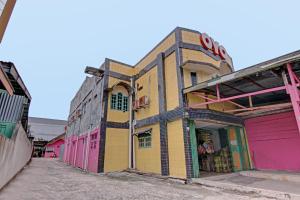 a row of colorful buildings on a street at OYO 3063 Homestay 22 Syariah in Dumai