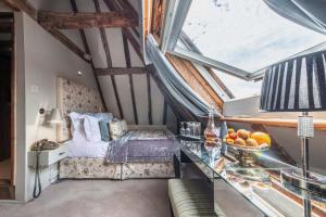 a bedroom with a bed and a glass table at The Great House Lavenham Hotel & Restaurant in Lavenham