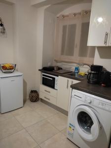 a kitchen with a washing machine and a washer at DORA'S APARTMENTS STUDIO 1 in Corfu