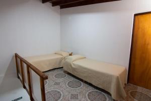 a room with two beds and a stair case at Departamento Casimiro-Nuevo Amplio en Zona Centro in El Calafate