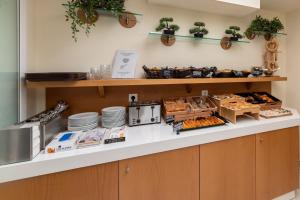 a bakery counter with plates and pastries at Hotel Hermes in Rhodes Town