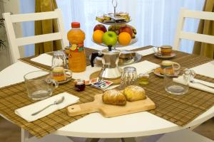 a table with a plate of food on top of it at Residenza Sforza Apartment 1 in Naples +21 photos