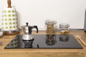 a kitchen counter with a coffee maker on a stove at Residenza Sforza Apartment 1 in Naples