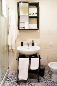 a bathroom with a sink and a toilet at Residenza Sforza Apartment 1 in Naples