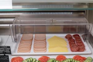 a display case with different types of meats and cheese at Hotel Hermes in Rhodes Town