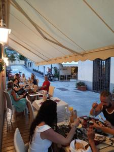 a group of people sitting at tables in a restaurant at Hotel Ristorante San Celso in Varazze