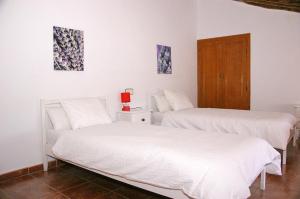 En eller flere senge i et værelse på Cortijo El Álamo
