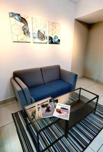 a living room with a couch and a coffee table at C3111 Muji Home Almas Suites100mbps Netflix Youtube by STAY in Nusajaya