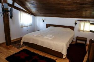 a bedroom with a bed with two towels on it at Delchovski Han in Delchevo