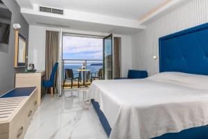 a hotel room with a bed and a balcony at Grand Hotel Park in Dubrovnik