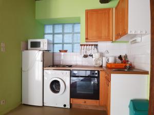 a kitchen with a washing machine and a washer at Chalet Le Sambuis in Saint-Colomban-des-Villards