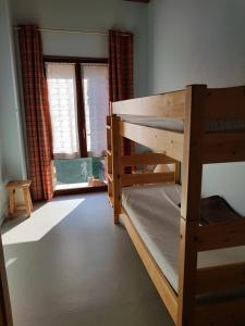 a room with two bunk beds and a window at Chalet Le Sambuis in Saint-Colomban-des-Villards