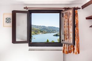 a window with a view of a lake at Gerês Mountain Lake Views in Geres