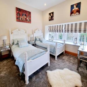 a bedroom with two beds and a window at DOLLARBEG CASTLE - The Tower - Luxury Apartment in Dollar