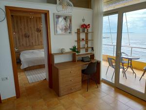 a bedroom with a desk and a bed and a table at Apartmán Dagmar in Durrës