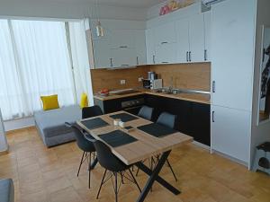 a kitchen with a table and chairs in a room at Apartmán Dagmar in Durrës +12 photos
