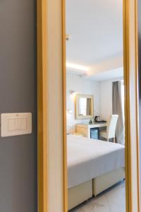 a bedroom with a bed and a desk and a mirror at Grand Hotel Park in Dubrovnik