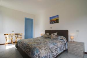 a bedroom with a bed and a table and chairs at La Casetta in Tremezzo