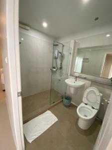 a bathroom with a shower and a toilet and a sink at Siri Ville Hotel in Si Sa Ket +20 photos