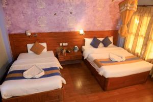 Rúm í herbergi á Chitwan Forest Resort , Chitwan National Park