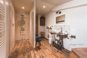a bathroom with a sink and a mirror at L’échappée Vendéenne in Saint-Aubin-la-Plaine