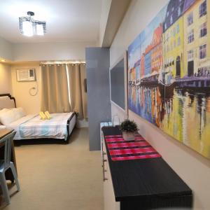 a room with a bedroom with a bed and a table at Avida Davao Condos, downtown CM Recto Avenue, Davao City in Davao City