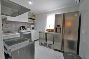 a kitchen with a large stainless steel refrigerator at Casa Rural Mañanas Felices in Martos
