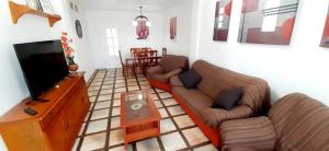 a living room with two couches and a flat screen tv at Villa Flor de Loto in Palazuelos