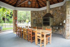 a dining room with a table and chairs and a fireplace at SESC CONTAGEM in Contagem