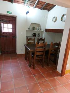 a dining room with a table and chairs at A Casinha da Vila in Vila Viçosa