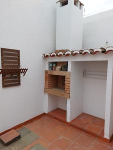 a small kitchen with a shelf on the wall at A Casinha da Vila in Vila Viçosa +10 photos