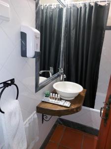 a bathroom with a sink and a black shower curtain at A Casinha da Vila in Vila Viçosa