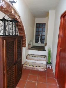 a hallway with stairs in a house with a window at A Casinha da Vila in Vila Viçosa