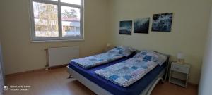 een kleine slaapkamer met een bed en een raam bij OneBeach Apartman in Siófok