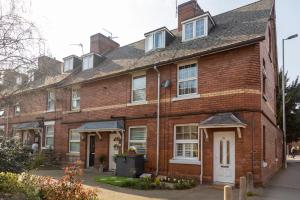 an old brick house with a white door at St Owen's Terrace by RentMyHouse in Hereford